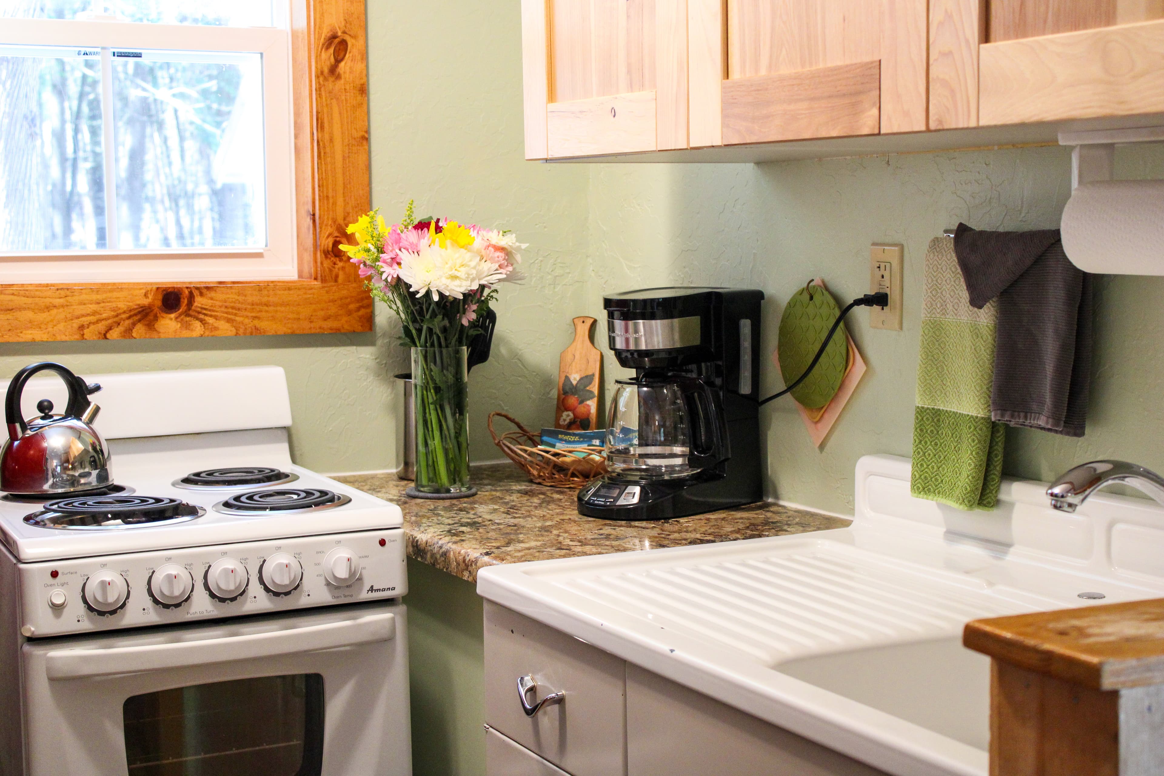 A kitchen area with countertops and vanity sink.
