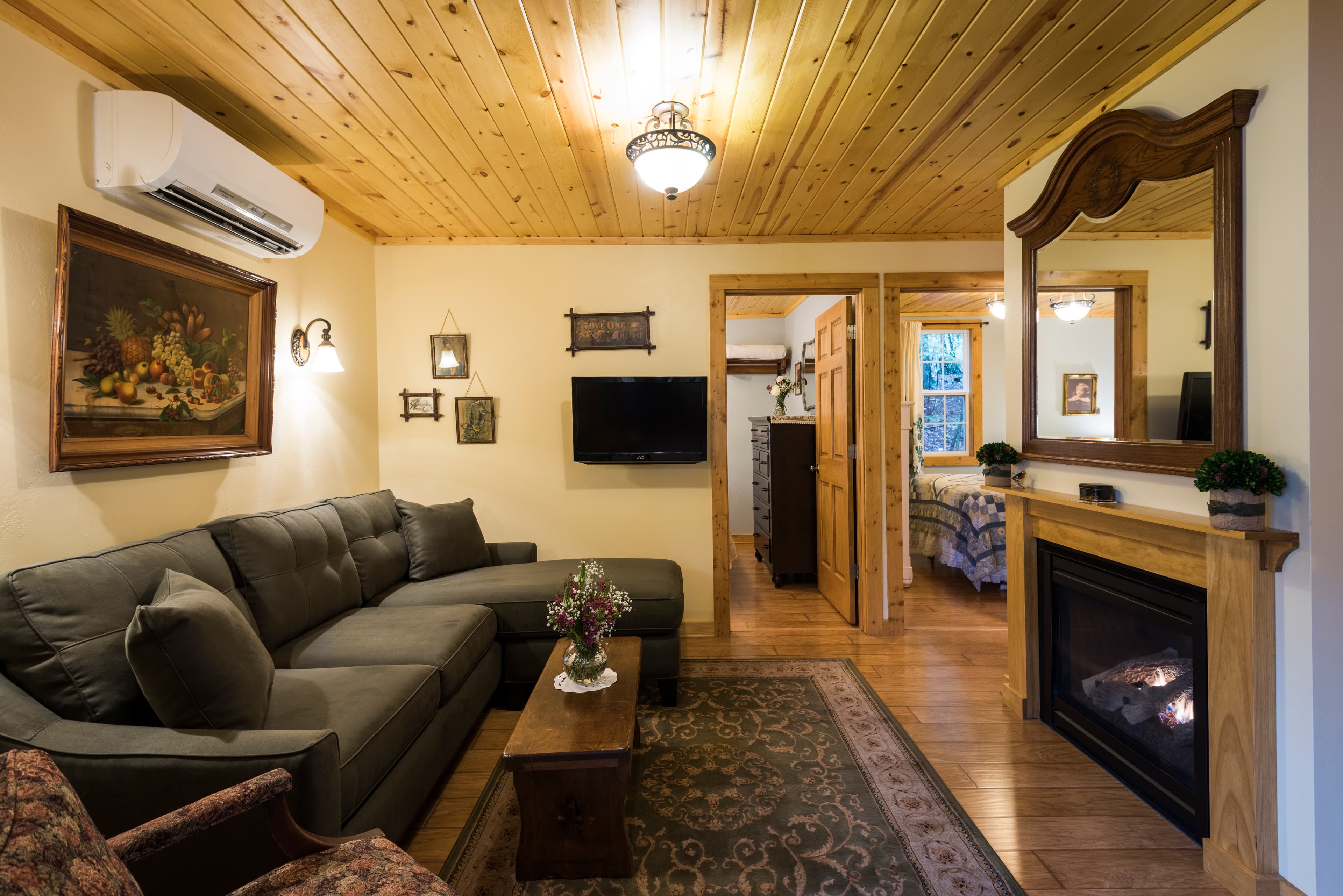 Family room with fireplace and TV with couch and chairs